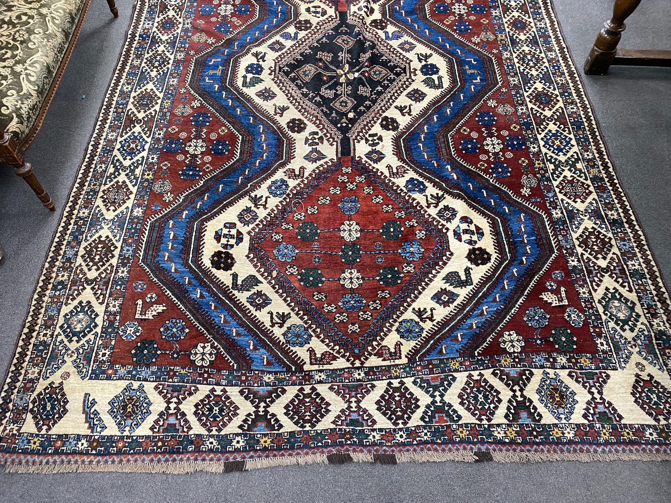 A Caucasian red ground carpet, 335 x 214cm